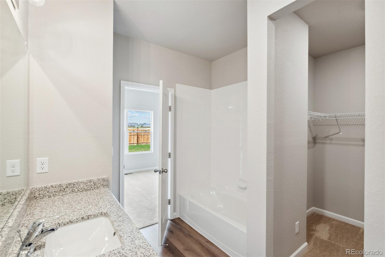 977 Ouzel Falls Road Severance, CO 80550 - Photo 14 of 19 a bathroom with a bathtub and a sink