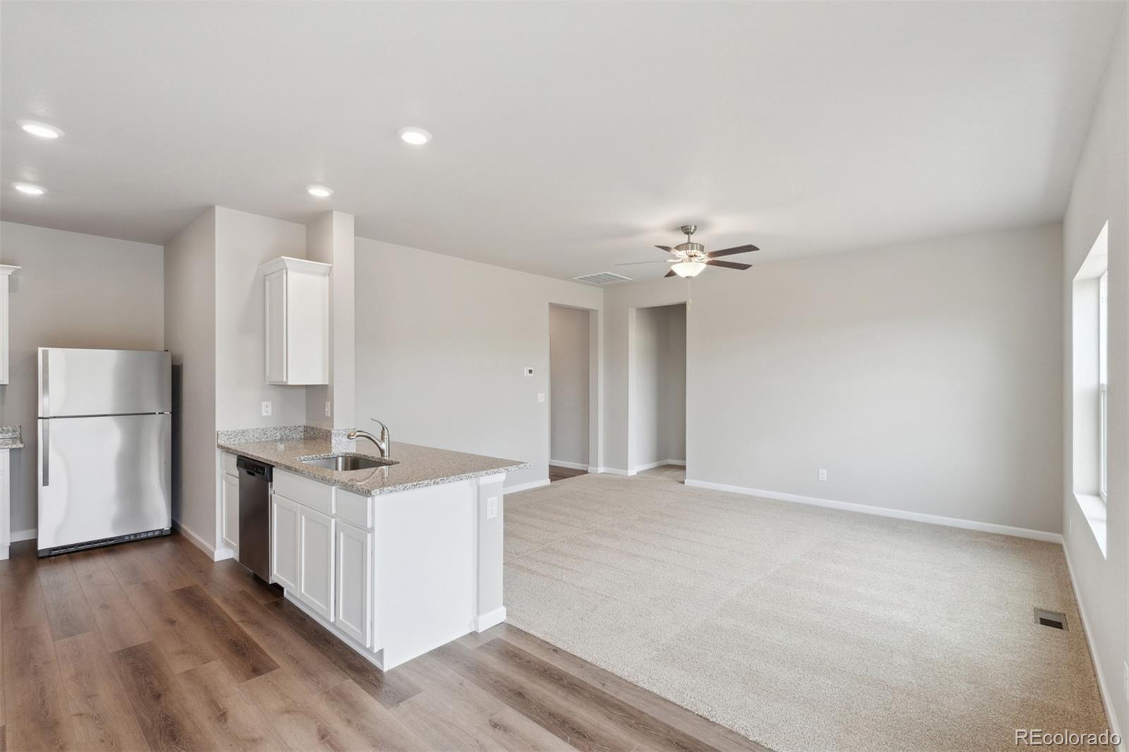 977 Ouzel Falls Road Severance, CO 80550 - Photo 6 of 19 a view of a kitchen with a sink and a refrigerator