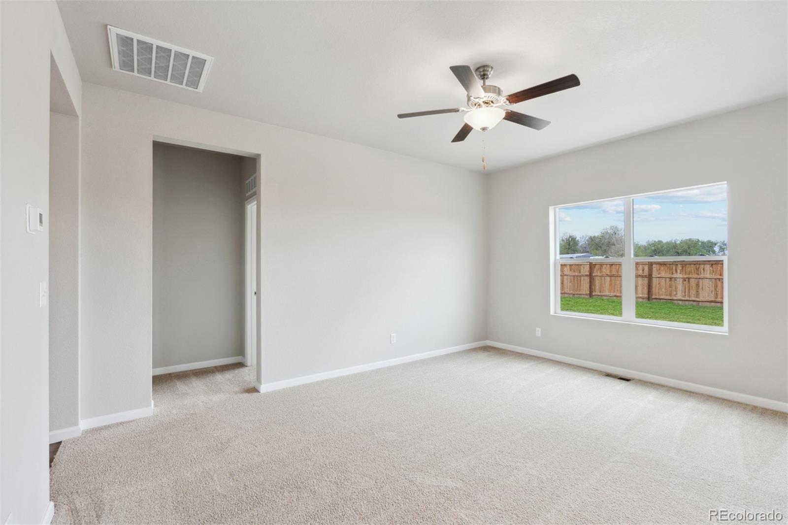 977 Ouzel Falls Road Severance, CO 80550 - Photo 10 of 19 a view of an empty room with a window