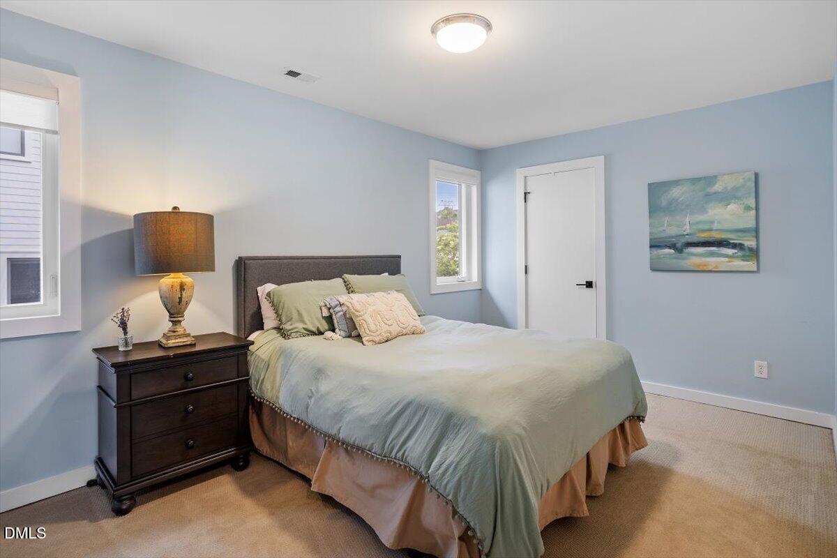 1410 Duplin Road Raleigh, NC 27607 - Photo 34 of 54 a bedroom with a bed and painting on the wall
