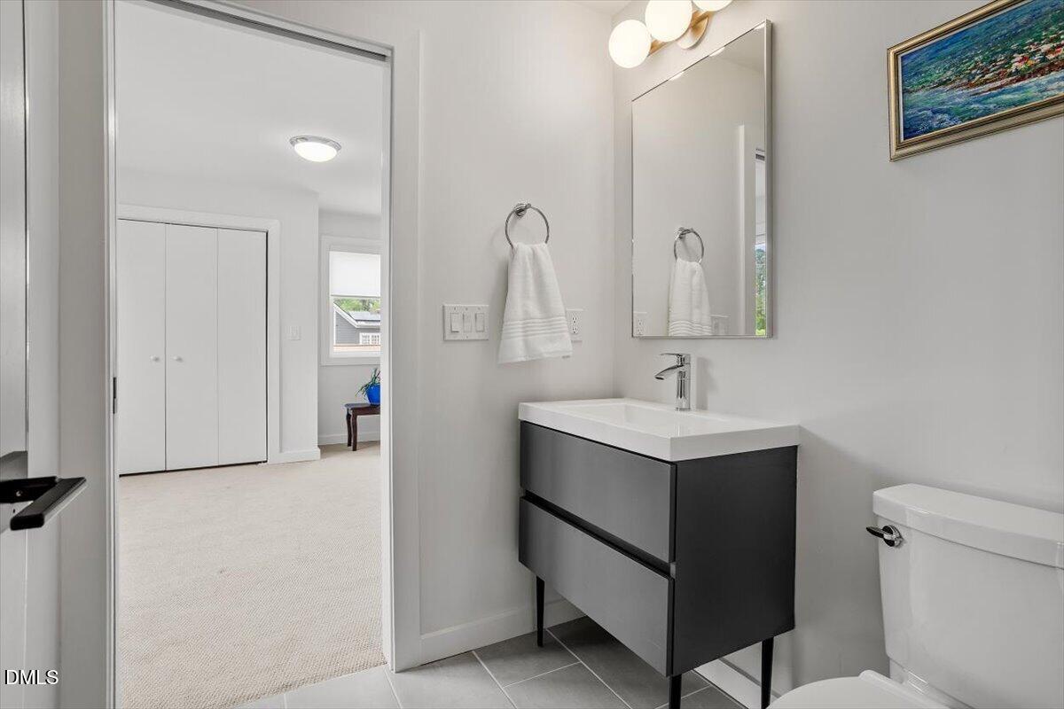1410 Duplin Road Raleigh, NC 27607 - Photo 46 of 54 a bathroom with a sink vanity and a mirror