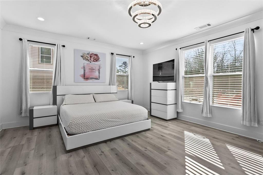 658 Rockbridge Road Northwest Lilburn, GA 30047 - Photo 18 of 61 a spacious bedroom with a bed and a television