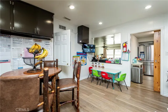 a living room with furniture and a baby crib