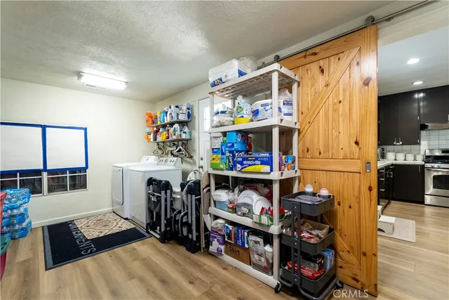 a living room with furniture and a dining table with rug