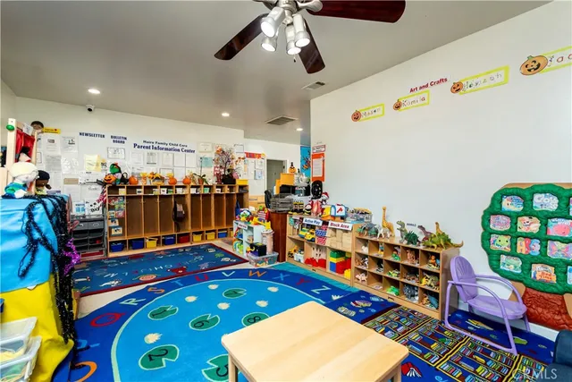 a kitchen with stainless steel appliances granite countertop wooden cabinets and chairs