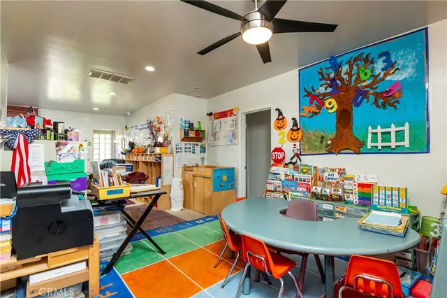 a kitchen with cabinets and chairs