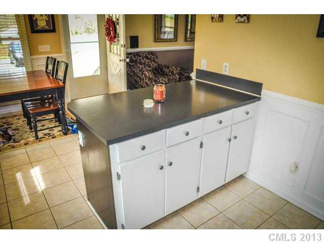 4915 Griffith Road Monroe, NC 28112 - Photo 11 of 16 a kitchen with stainless steel appliances granite countertop a sink and cabinets
