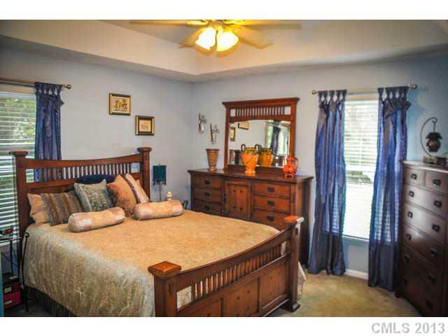 4915 Griffith Road Monroe, NC 28112 - Photo 15 of 16 a bedroom with a bed and a dresser in it