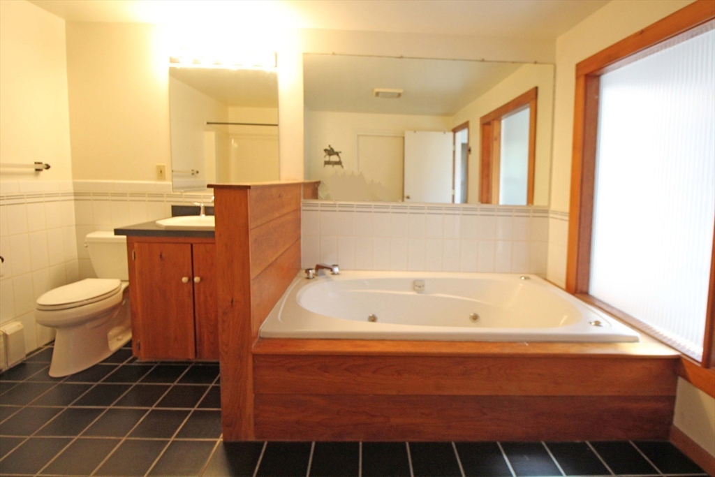 128 Amherst Road Pelham, MA 01002 - Photo 16 of 31 a bathroom with a bathtub and a toilet