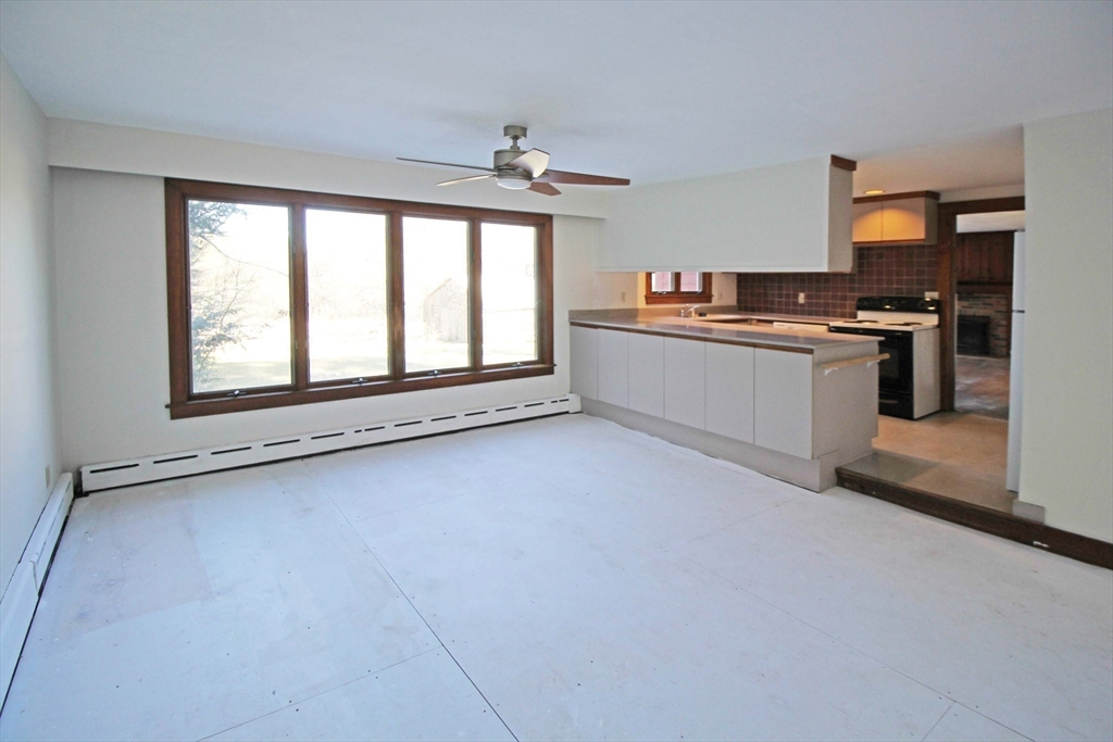 128 Amherst Road Pelham, MA 01002 - Photo 7 of 31 a large kitchen with granite countertop a stove a sink and a refrigerator