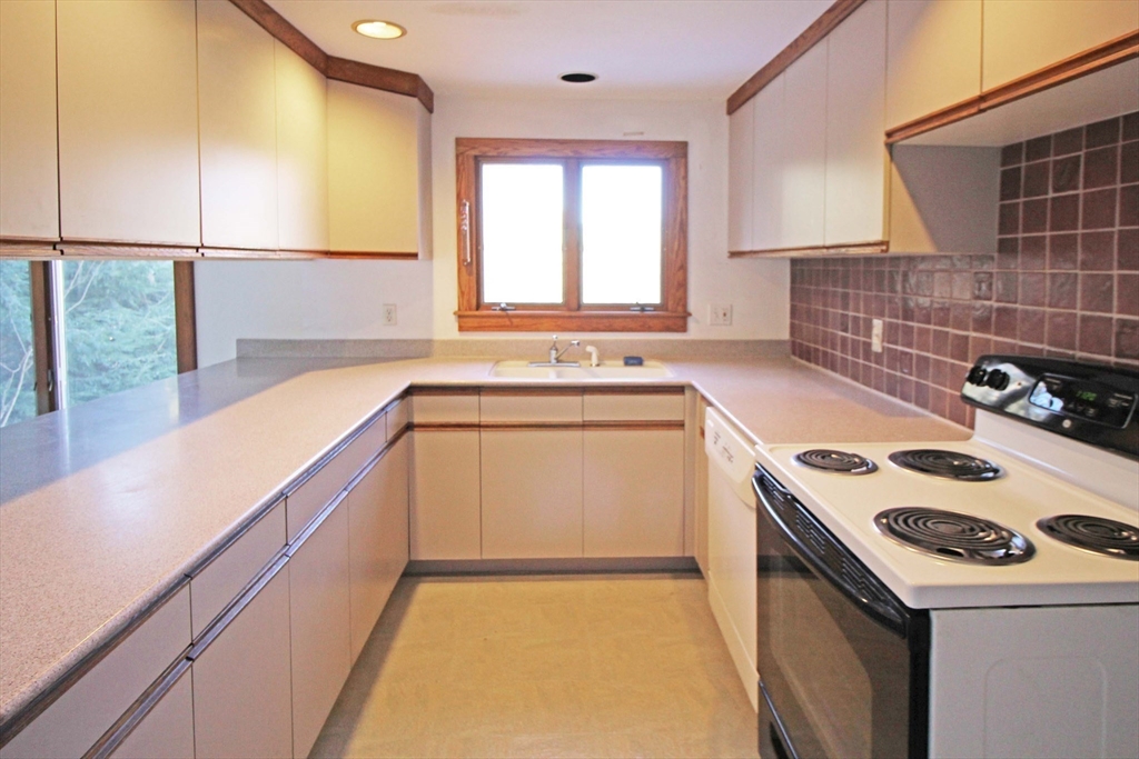 128 Amherst Road Pelham, MA 01002 - Photo 8 of 31 a kitchen that has a sink and a stove