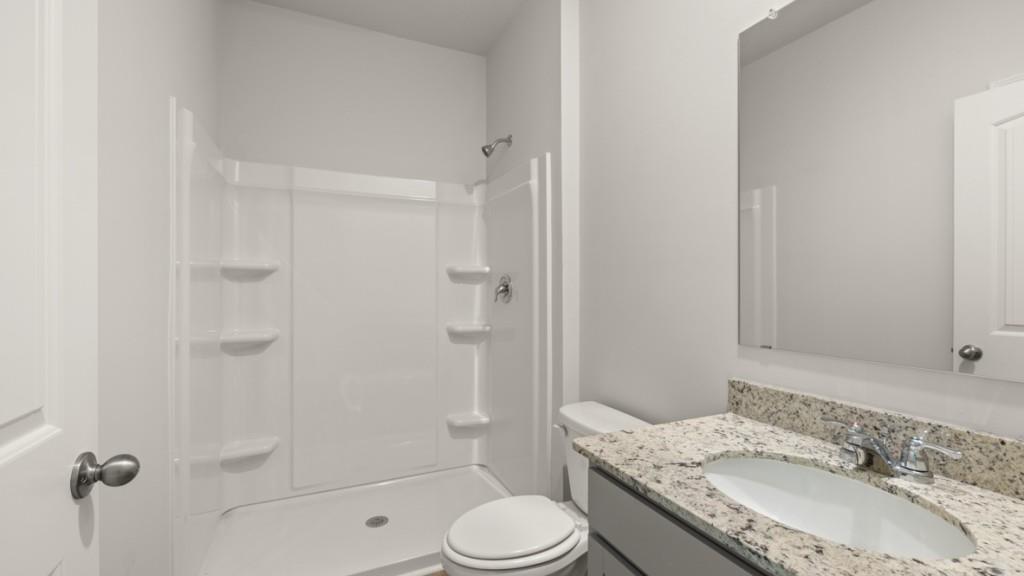 92 Cyrilla Walk Dallas, GA 30132 - Photo 13 of 35 a bathroom with a granite countertop sink toilet and shower