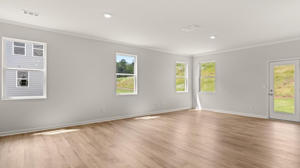 92 Cyrilla Walk Dallas, GA 30132 - Photo 7 of 35 a view of an empty room with wooden floor and a window