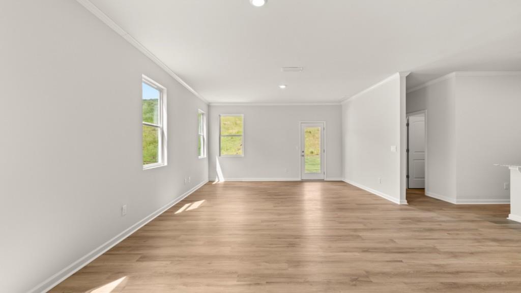 92 Cyrilla Walk Dallas, GA 30132 - Photo 8 of 35 a view of an empty room with wooden floor and a window