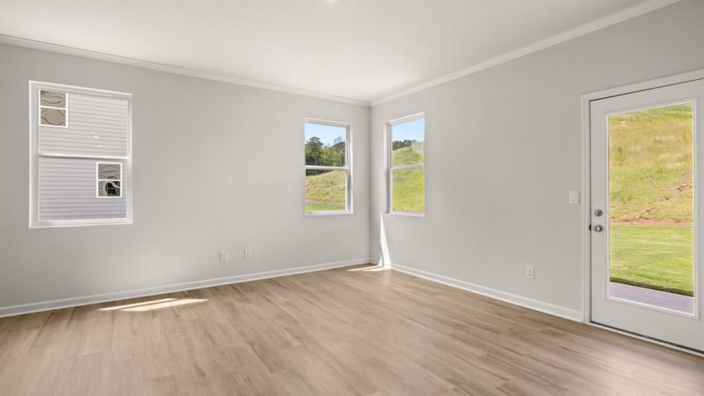 92 Cyrilla Walk Dallas, GA 30132 - Photo 9 of 35 an empty room with wooden floor and windows