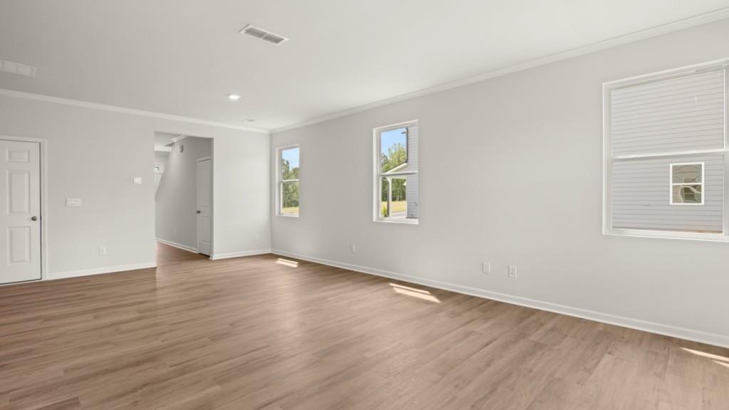 92 Cyrilla Walk Dallas, GA 30132 - Photo 10 of 35 an empty room with wooden floor and windows