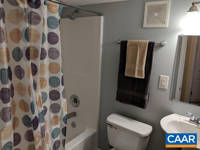 212 Spicers Mill Road Orange, VA 22960 - Photo 26 of 38 a bathroom with a toilet and a shower curtain