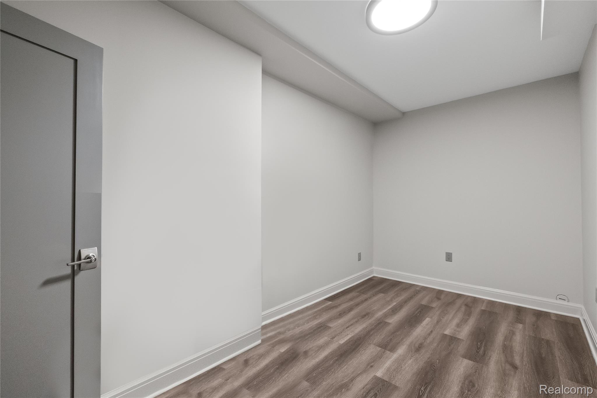 3824 Poppleton Street Troy, MI 48084 - Photo 39 of 51 Empty room featuring dark wood-style floors and baseboards