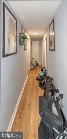 a hallway with furniture and wooden floor