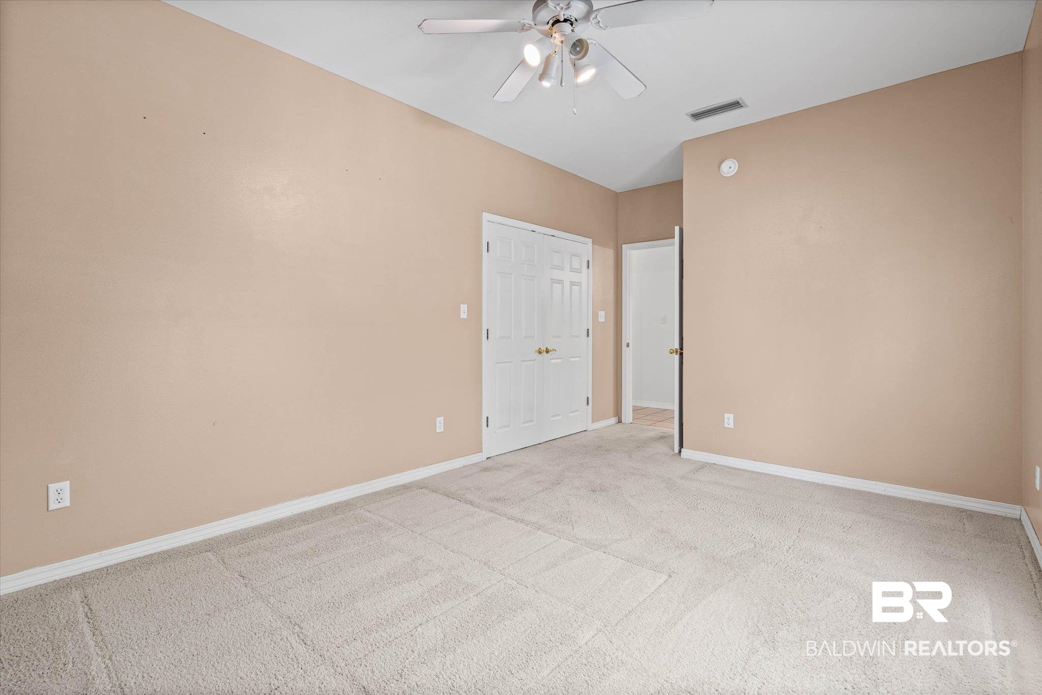 41923 Bayou Road Bay Minette, AL 36507 - Photo 18 of 35 Carpeted room featuring neutral wall tones, a ceiling fan with integrated lighting, and white baseboards