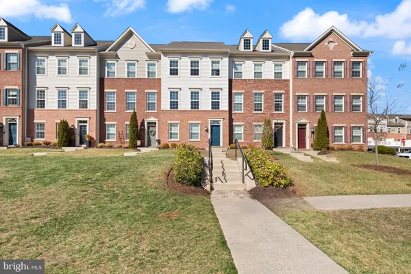 a front view of a residential apartment building with a yard