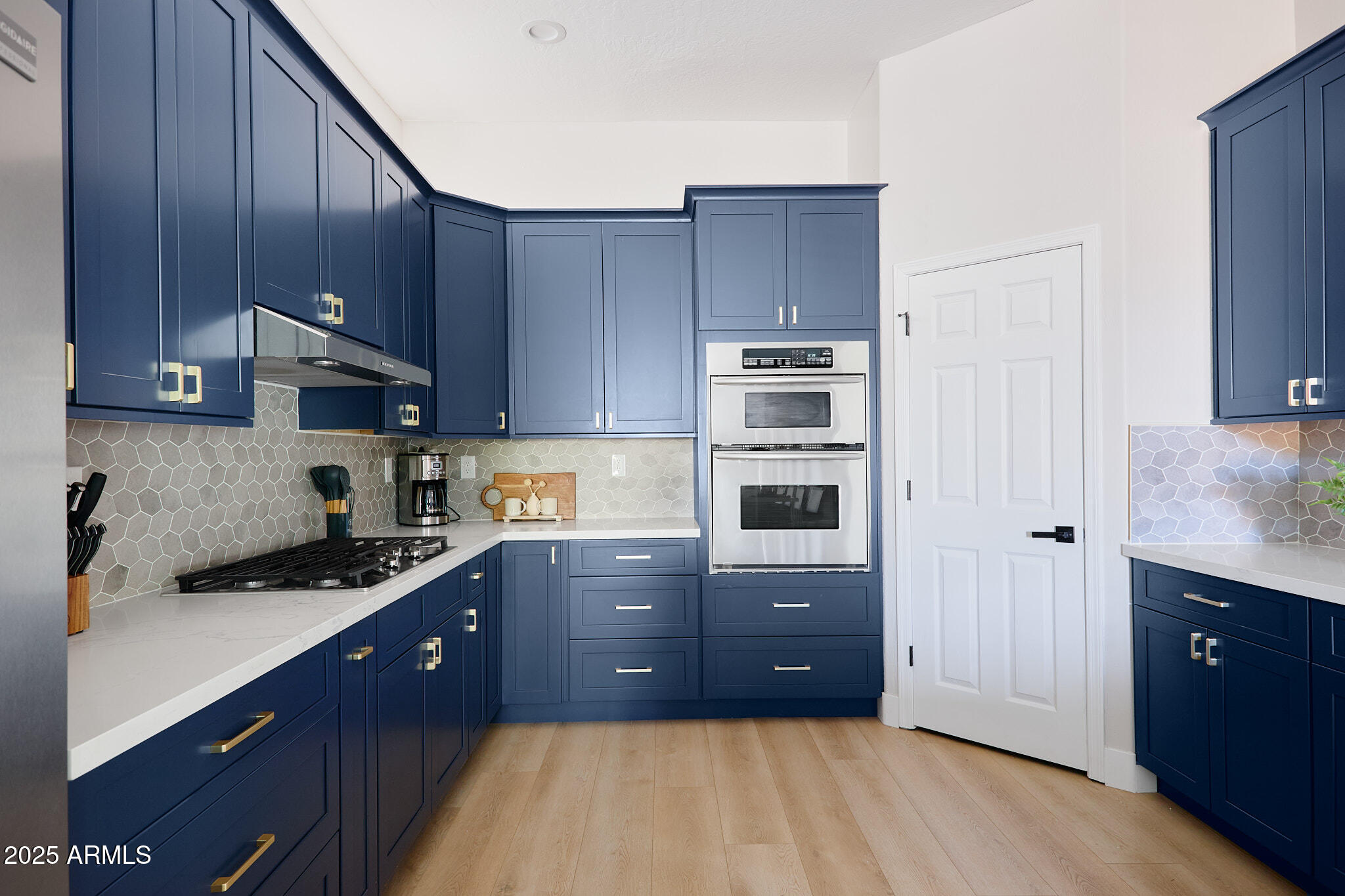 3202 East Orange Drive Phoenix, AZ 85018 - Photo 13 of 52 a kitchen with stainless steel appliances granite countertop a stove a sink and a refrigerator with wooden cabinets