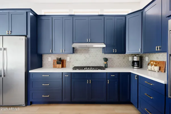 a kitchen with a sink a stove and cabinets