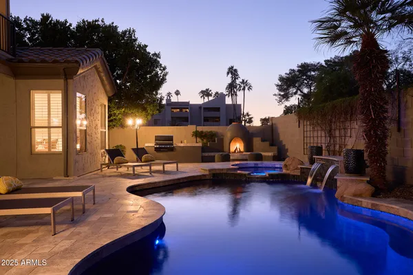 a view of a swimming pool with outdoor seating