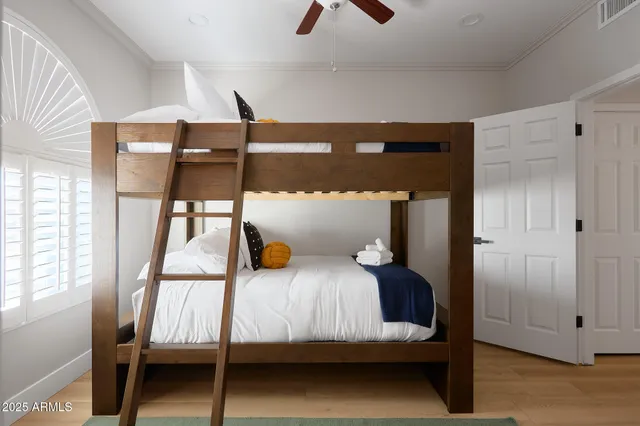 a bedroom with two beds and window
