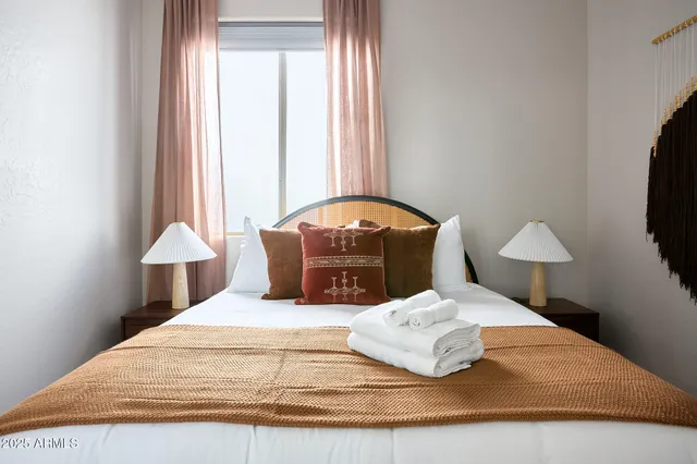 a bedroom with a bed and a flat screen tv