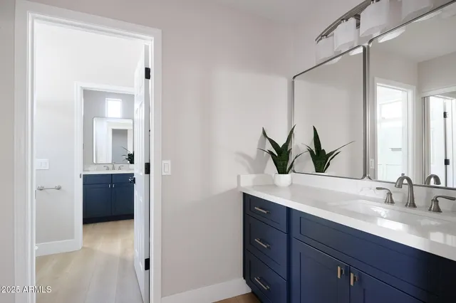 a bathroom with a double vanity sink and mirror
