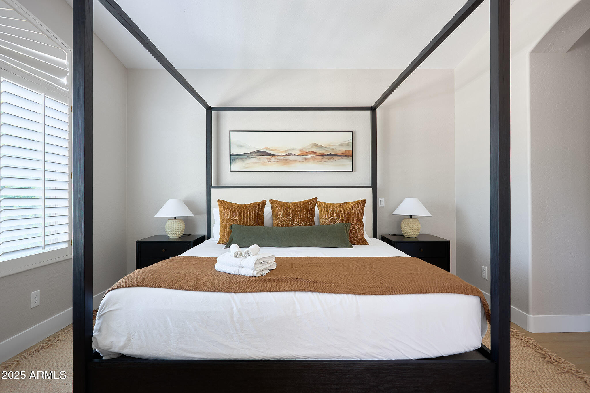 3202 East Orange Drive Phoenix, AZ 85018 - Photo 27 of 52 a bed sitting in a bedroom next to a window