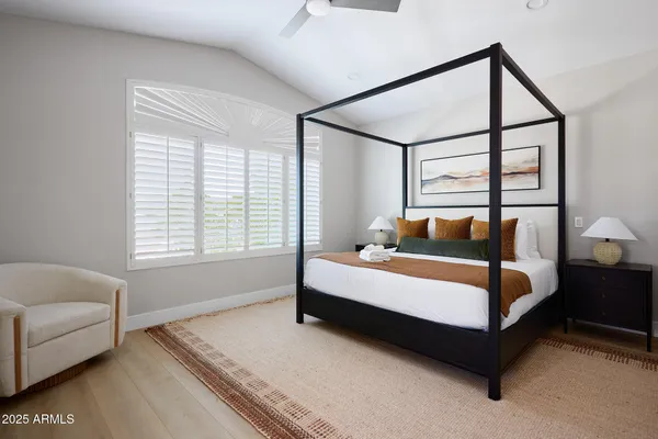 a bed sitting in a bedroom next to a window