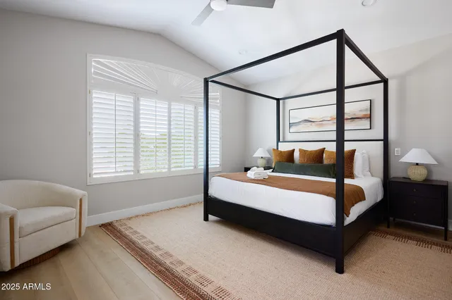 a bed sitting in a bedroom next to a window