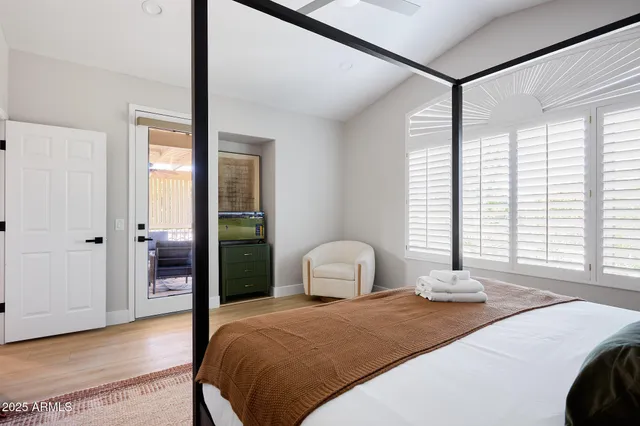 a bedroom with a bed and window