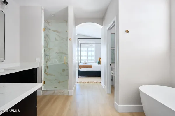 a en suite bathroom with a granite countertop sink and a mirror