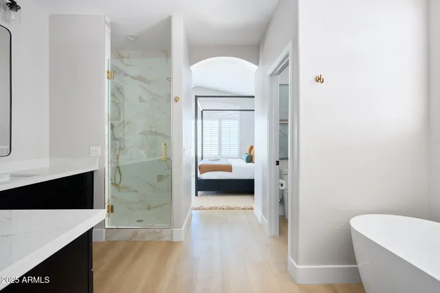 a en suite bathroom with a granite countertop sink and a mirror