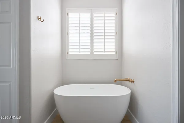 a white bath tub sitting in a bathroom