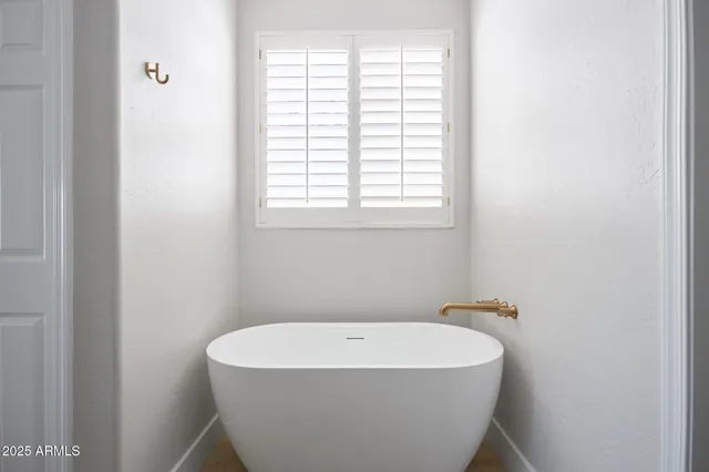 a white bath tub sitting in a bathroom