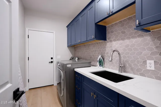 a kitchen with a sink a stove and cabinets