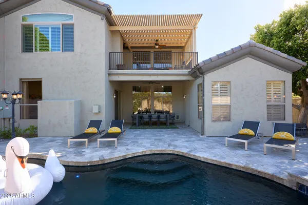 a view of a house with patio area and seating