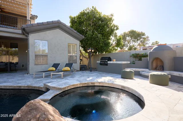a view of swimming pool with outdoor seating and plants