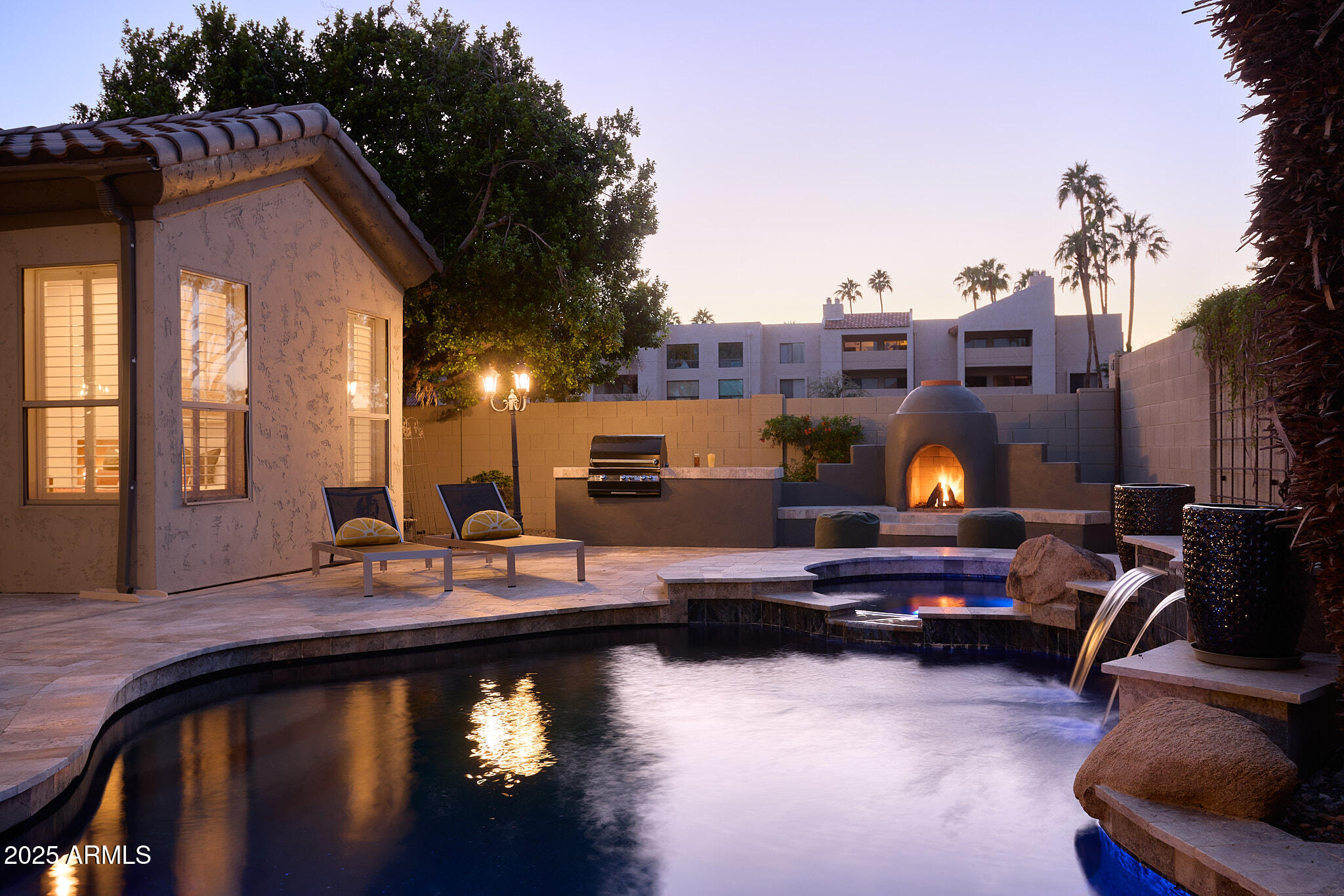 3202 East Orange Drive Phoenix, AZ 85018 - Photo 46 of 52 a living room with furniture a flat screen tv and a fireplace