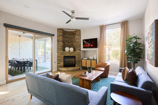 a living room with furniture fireplace and a large window