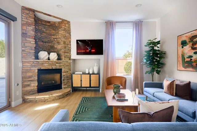 a living room with furniture and a fireplace