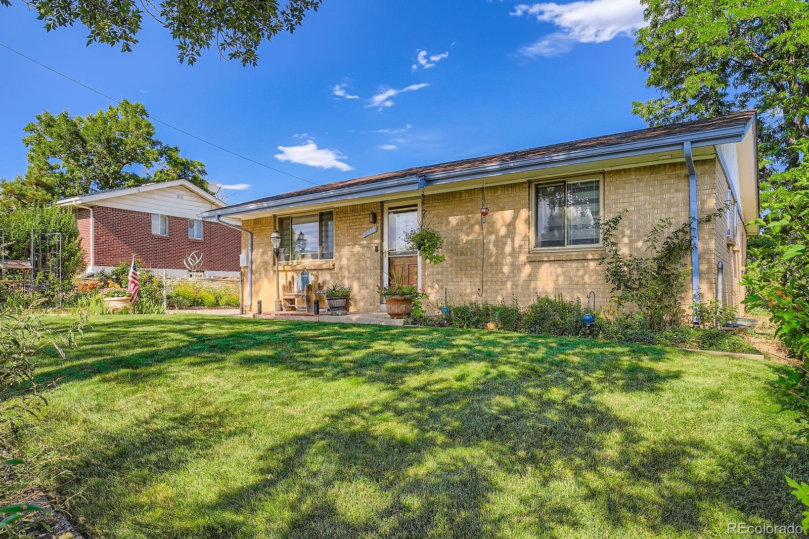 a front view of house with yard and green space
