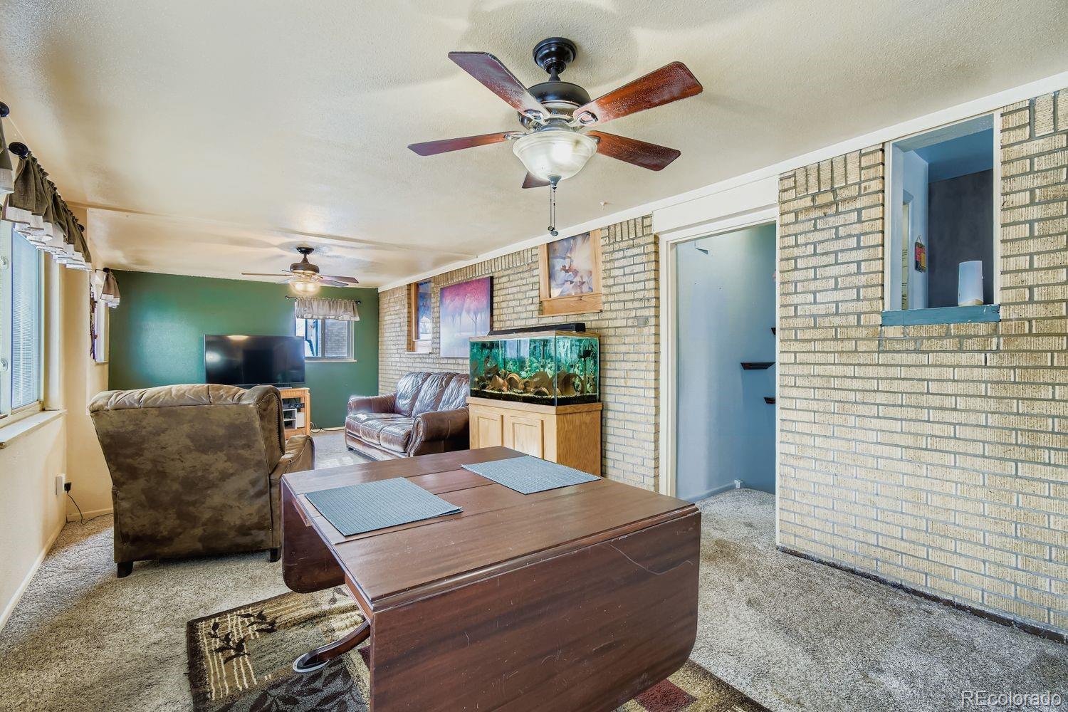 8510 Faraday Street Denver, CO 80229 - Photo 11 of 25 a living room with furniture and a chandelier