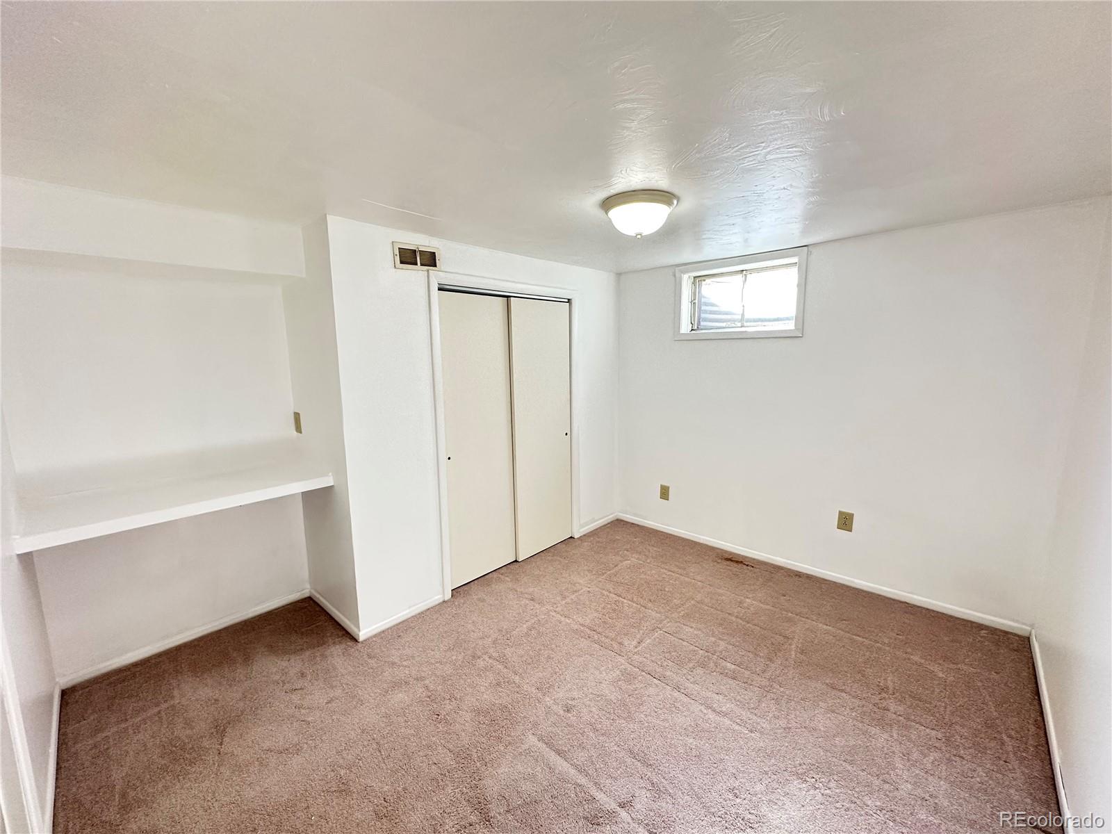 8510 Faraday Street Denver, CO 80229 - Photo 17 of 25 a view of an empty room with a window