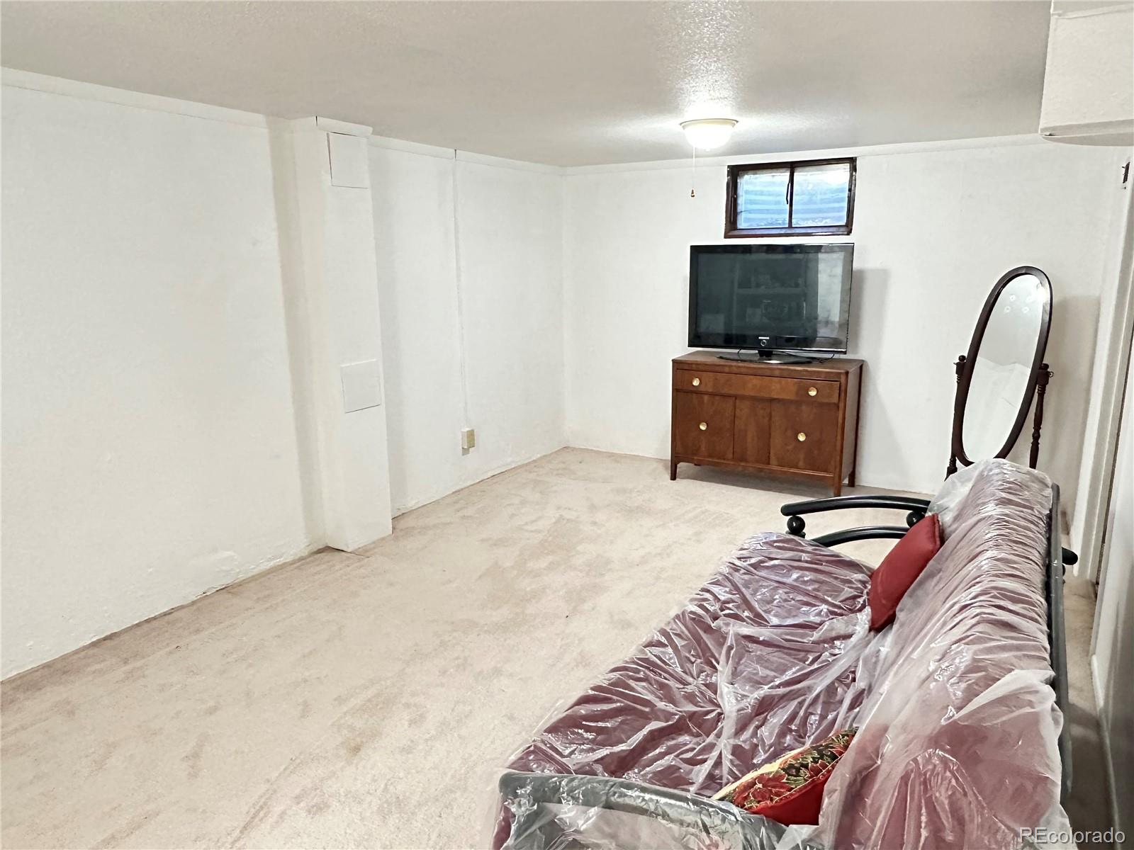 8510 Faraday Street Denver, CO 80229 - Photo 18 of 25 a bedroom with a bed and a television