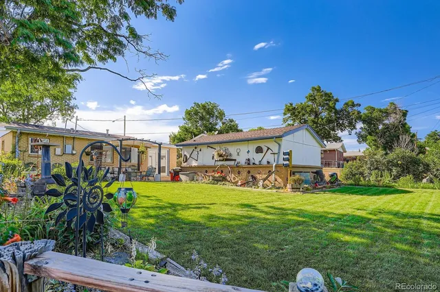 a view of a house with a yard and a garage